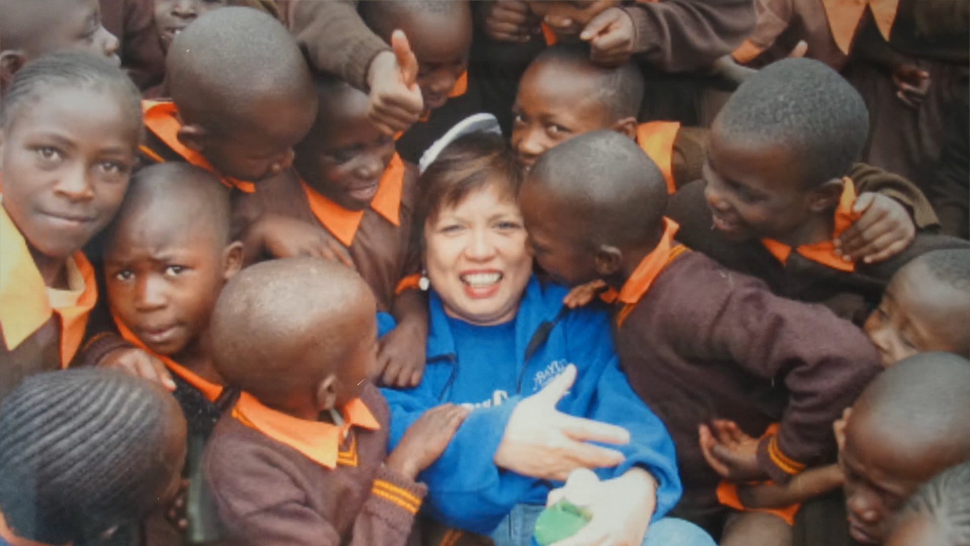 Susie Y. Jennings, R.N. washing feet at an Operation Care International Christmas Gift event